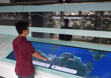 A person using a touchscreen to learn about geography