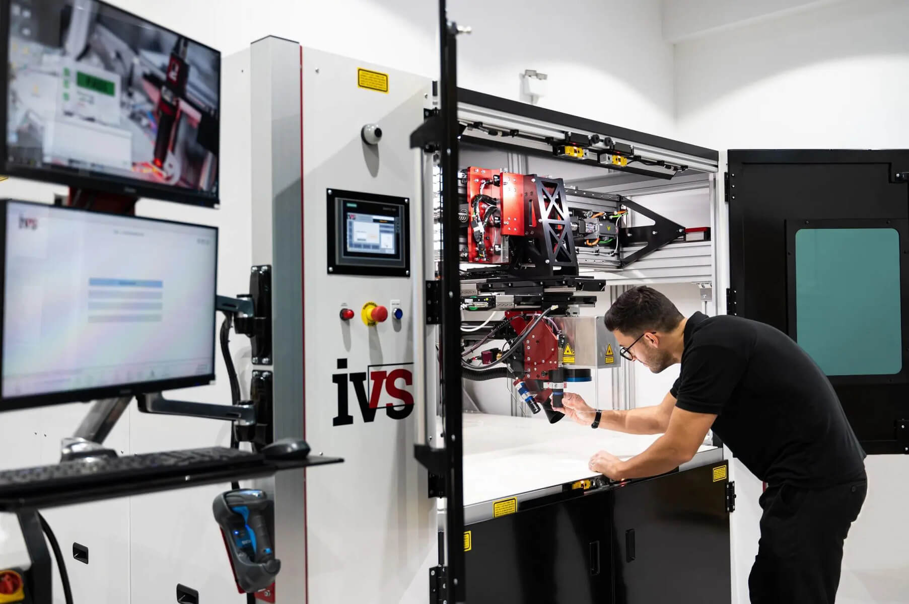 A Man Inspecting the Zytronic Laser Soldering System