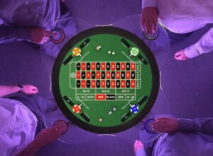 A round touchscreen table with four people playing roulette