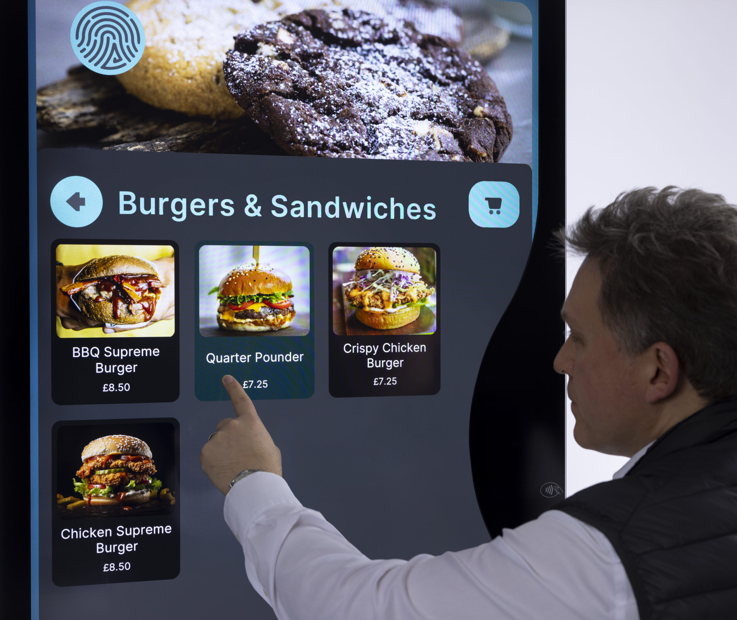 A man ordering food from a touchscreen kiosk