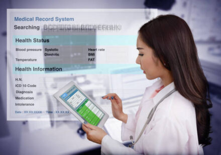 A doctor using a touchscreen to view a patients records