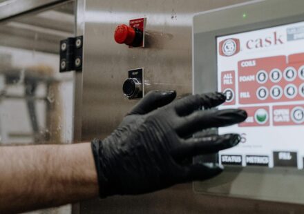 A person using a touchscreen in a factory