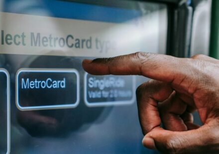 A person using a touchscreen to purchase a train ticket