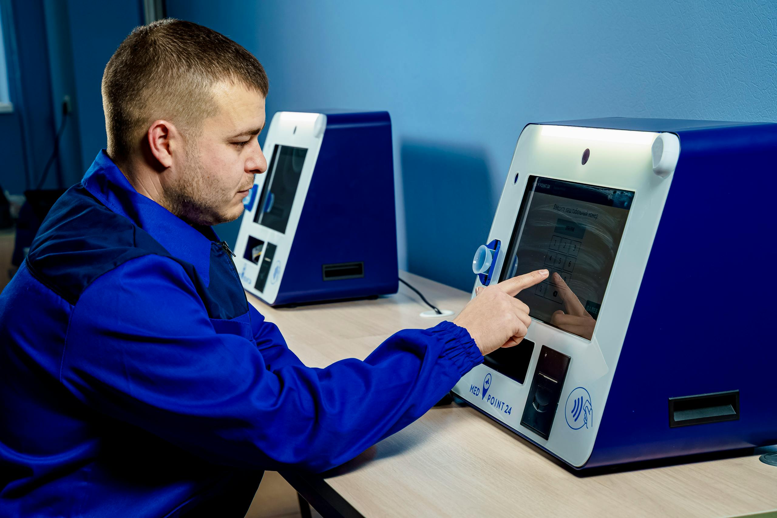 A worker using a touchscreen in a factory