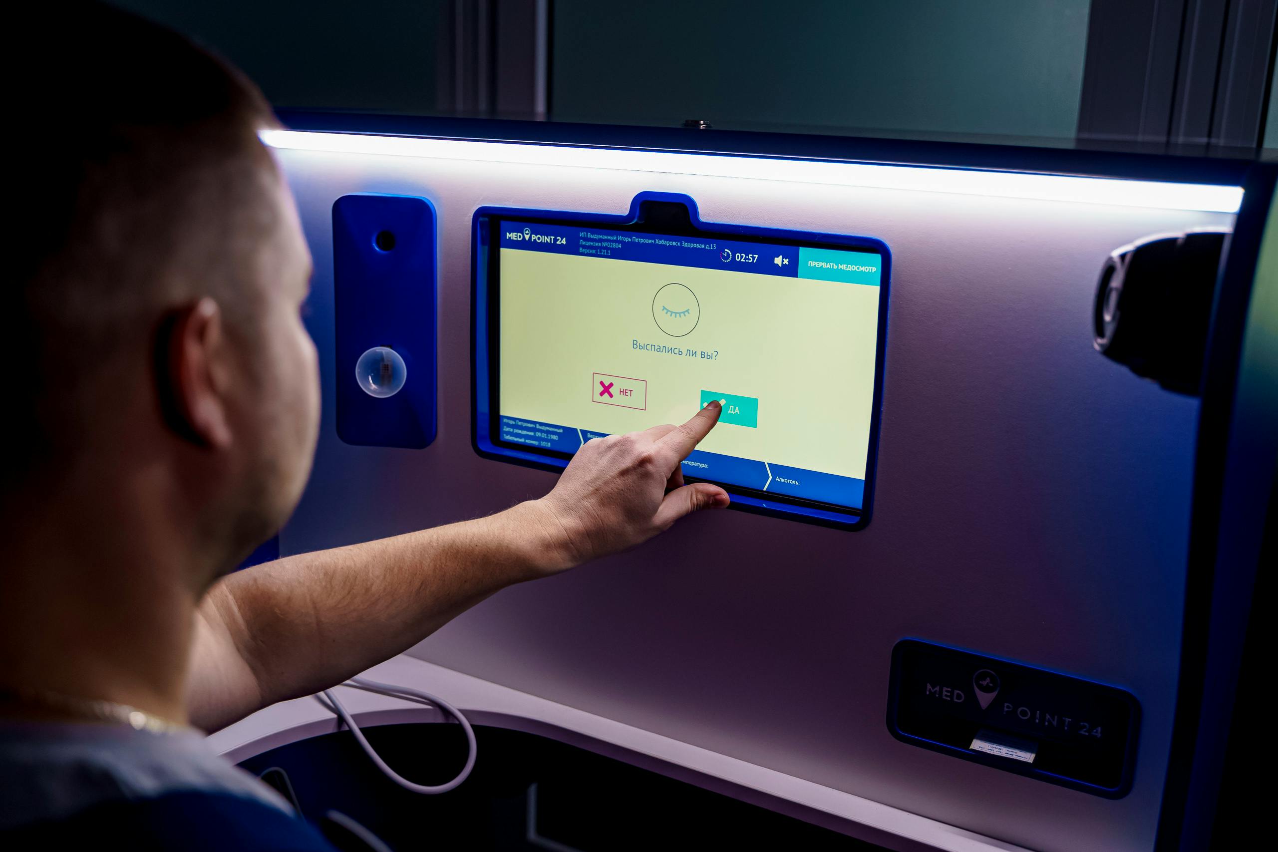 A user selecting inflight entertainment using a touchscreen on an aeroplane