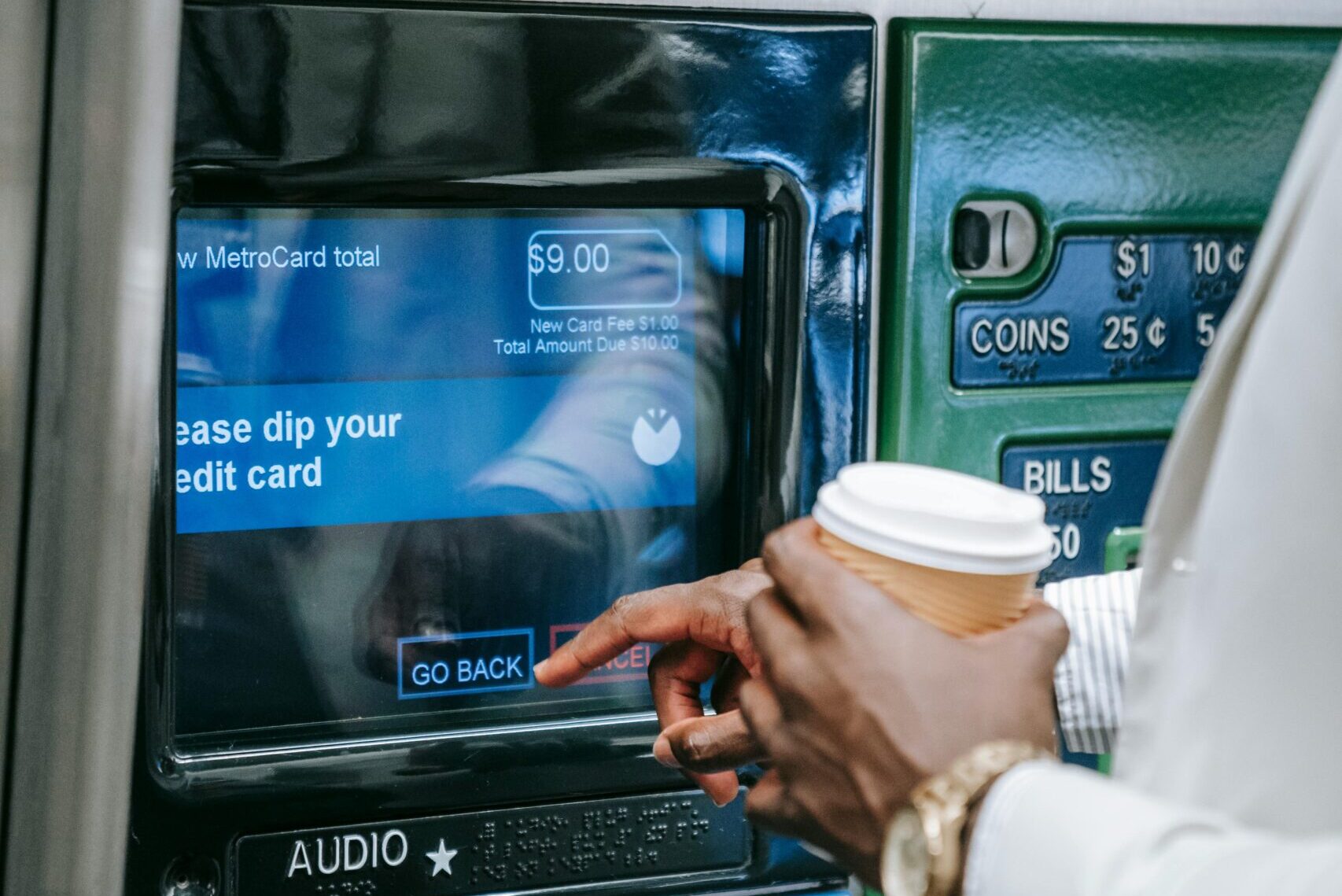 A person using a touchscreen ATM