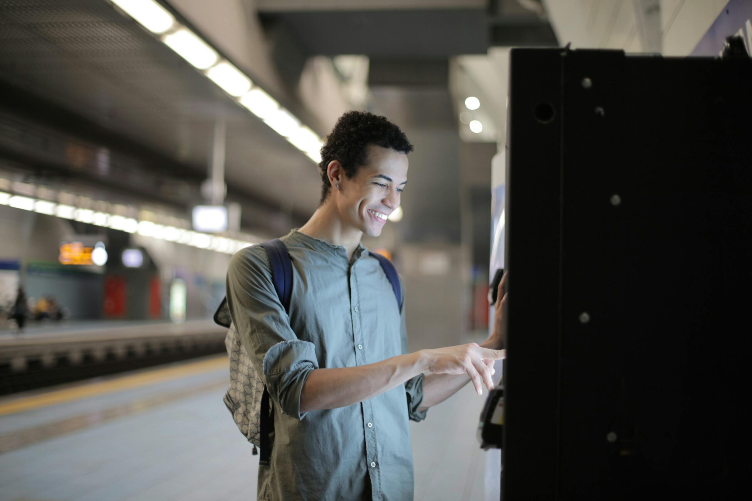 A person purchasing a train ticket in the train station