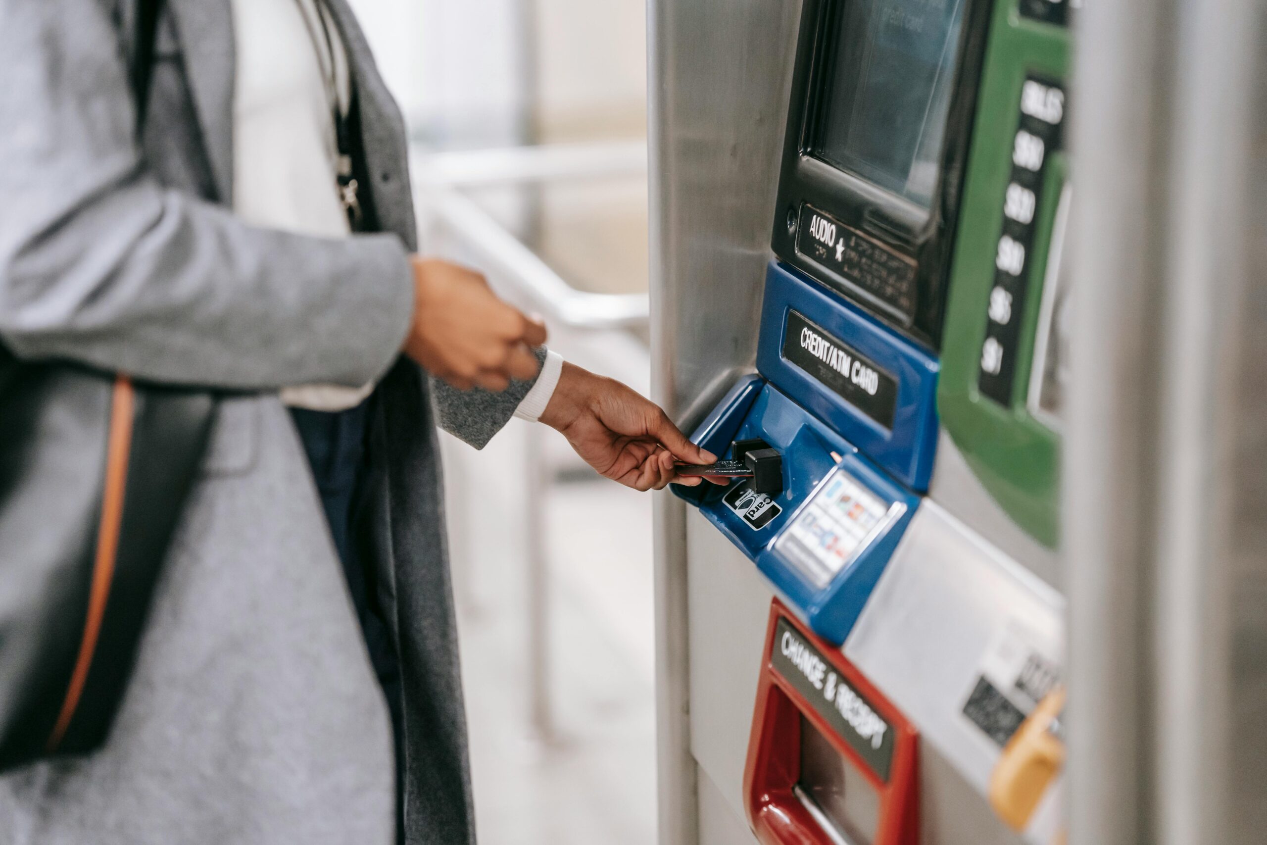 A person taking money out of a touchscreen ATM