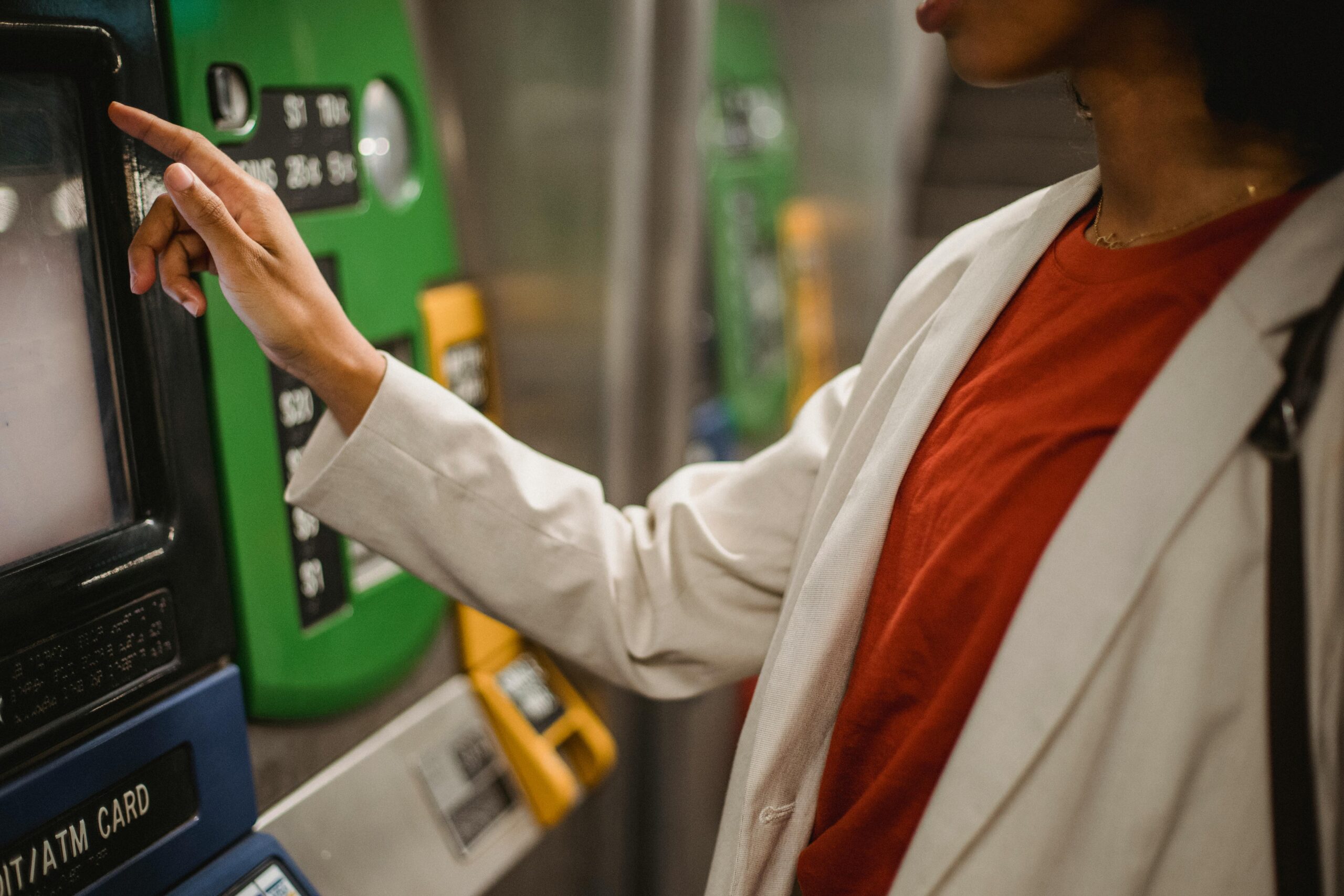 A person purchasing a ticket at a train station