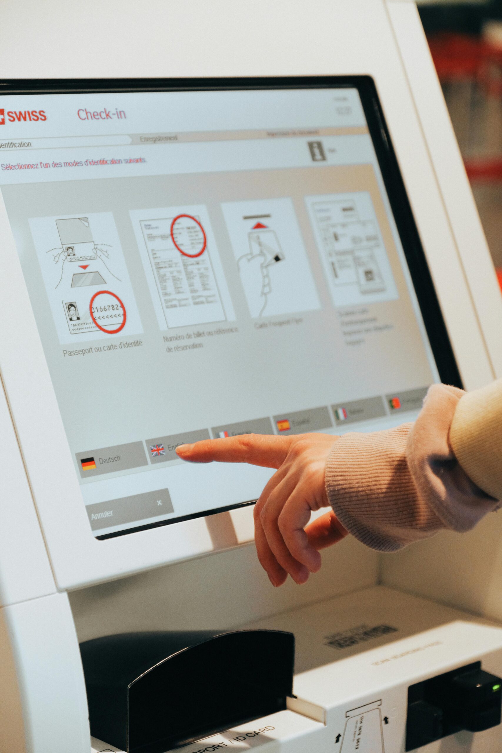 A person checking in using a touchscreen at the airport